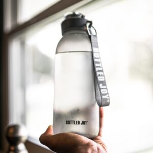 person holding gray and black tumbler