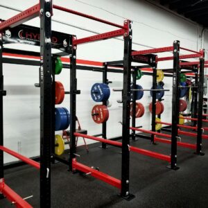 three red barbell machines