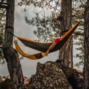 a person in a yellow tent from a tree