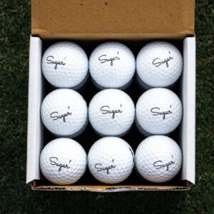 white golf balls in brown box