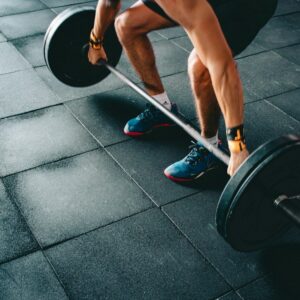 person holding black barbell